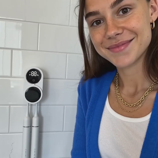 Brush Guard running a UV-C cycle on the wall beside a bathroom sink (15 s, no sound)