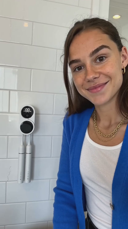 Brush Guard running a UV-C cycle on the wall beside a bathroom sink (15 s, no sound)